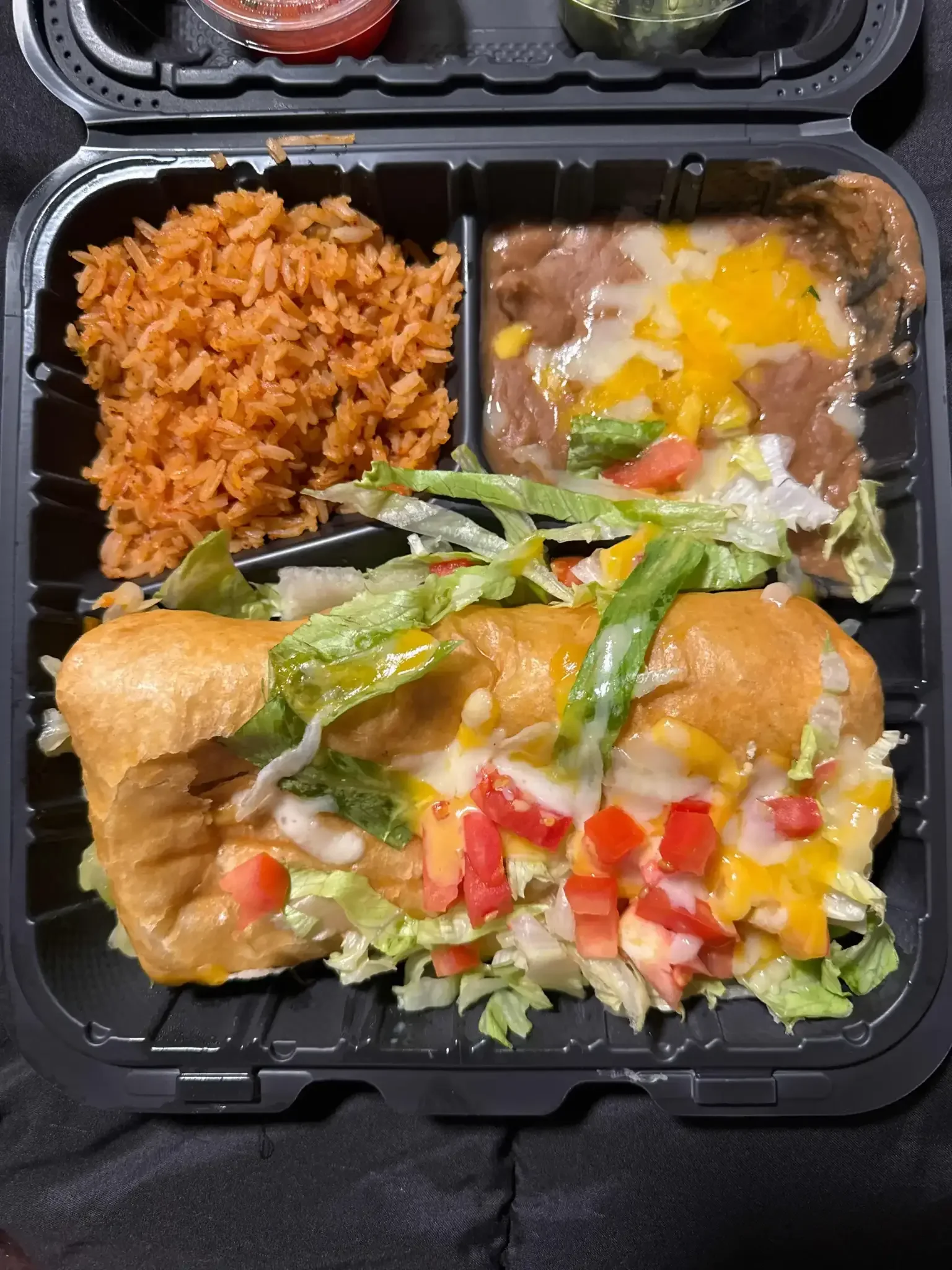 Chimichanga - A golden, crispy deep-fried burrito stuffed with seasoned meat, rice, beans, and cheese, served with sour cream and guacamole