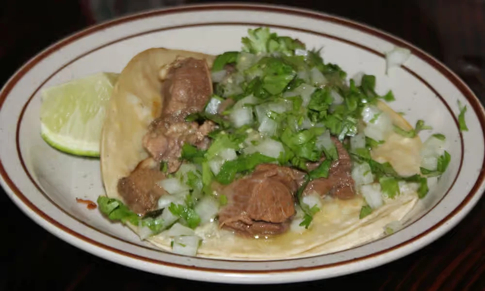 Street Tacos - Authentic street-style tacos on warm corn tortillas with cilantro, onion, and your choice of meat