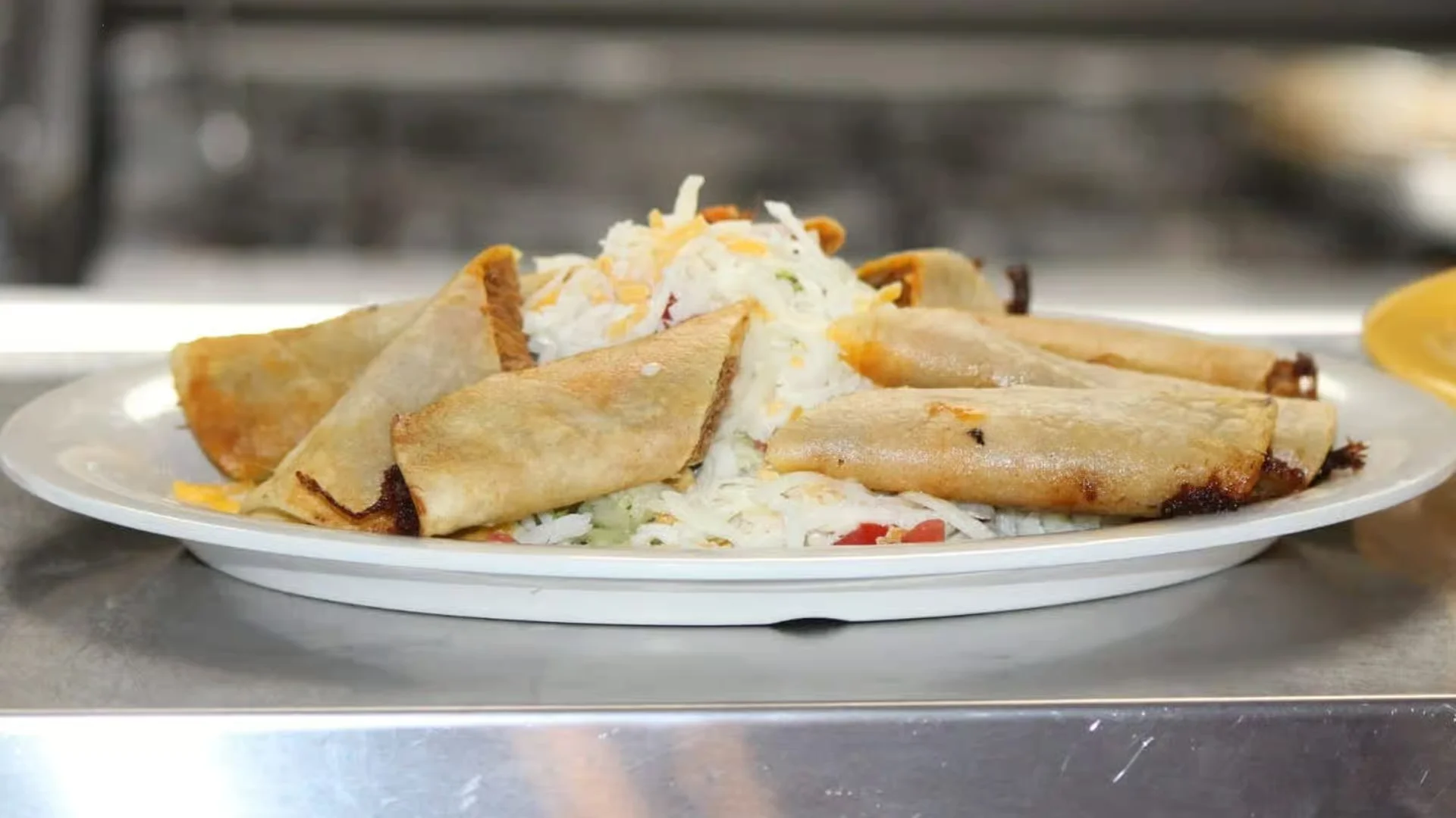 Taquitos - Crispy rolled corn tortillas filled with seasoned chicken or beef, served with guacamole and sour cream