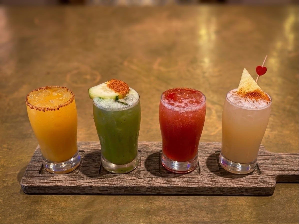 Four small margaritas on a wooden paddle at the Mi Pueblo bar in downtown Santa Rosa: mango, cucumber, strawberry and pineapple, with chili-salt rims